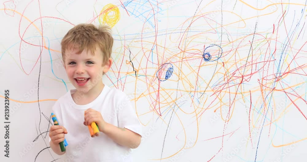 Little boy proudly standing in front of his giant drawing