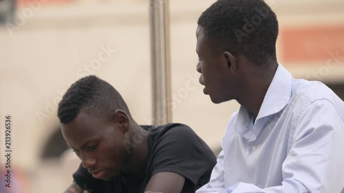 Wallpaper Mural Family support. sad young black man is comforted by his old brother- outdoor Torontodigital.ca