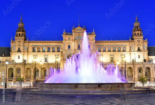 Night view over Plaza de Espana with illuminated fountain and Cntral Palace , Seville, Andalusia, Spain photo