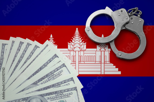 Cambodia flag  with handcuffs and a bundle of dollars. The concept of illegal banking operations in US currency photo