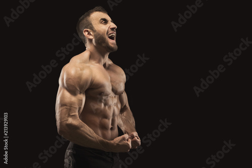 Strong athletic man showes naked muscular body