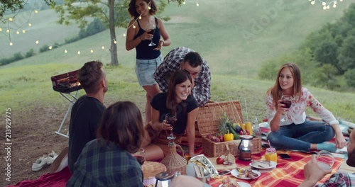 Group of friends spending time making a picnic and a barbeque. shot in slow motion