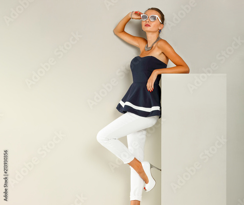 Slim young woman in studio and fashion photo . 