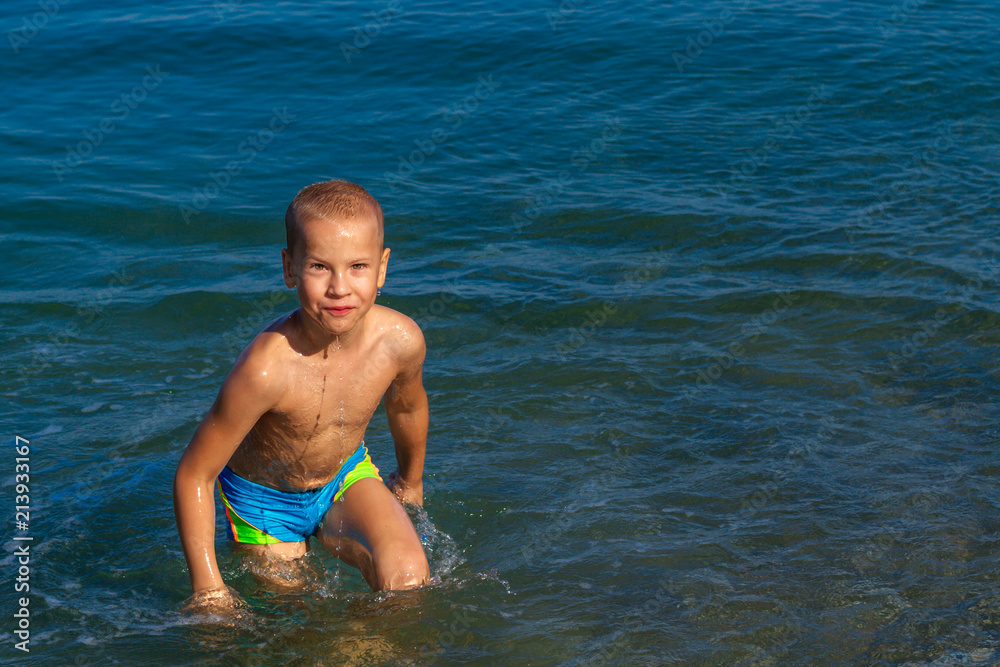 boy having fun and swimming in the sea