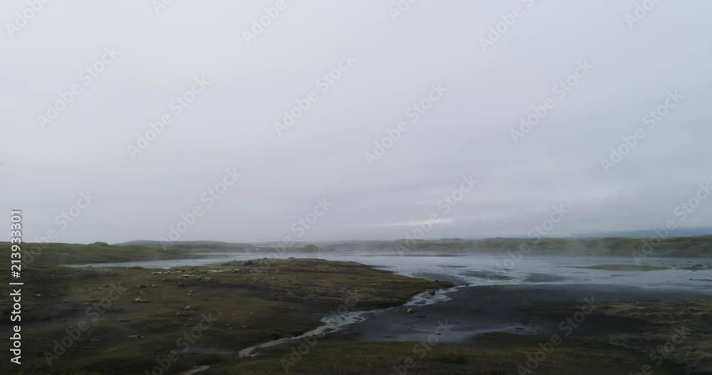 aerial drone view of black sand with grassland covered in fog in iceland aerial drone view of black sand with grassland covered in fog in iceland