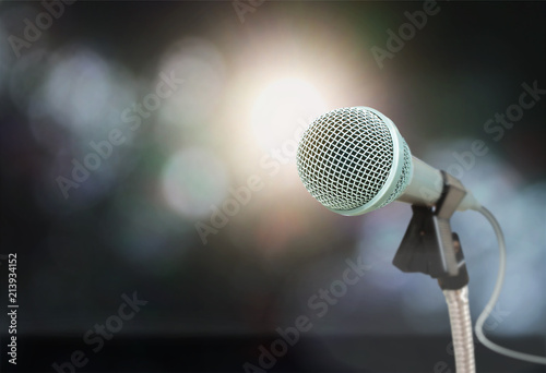 The microphone isolated on the blurry image of the stage in the meeting celebration festival during a night show abstract background.