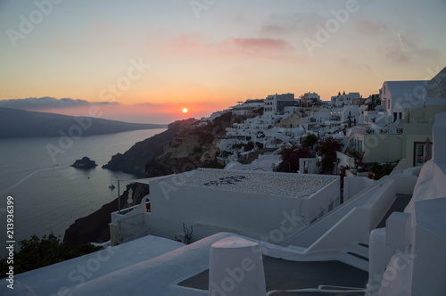 Whitewashed Houses on Cliffs with Sea View and Sunset in Oia, Santorini, Cyclades, Greece