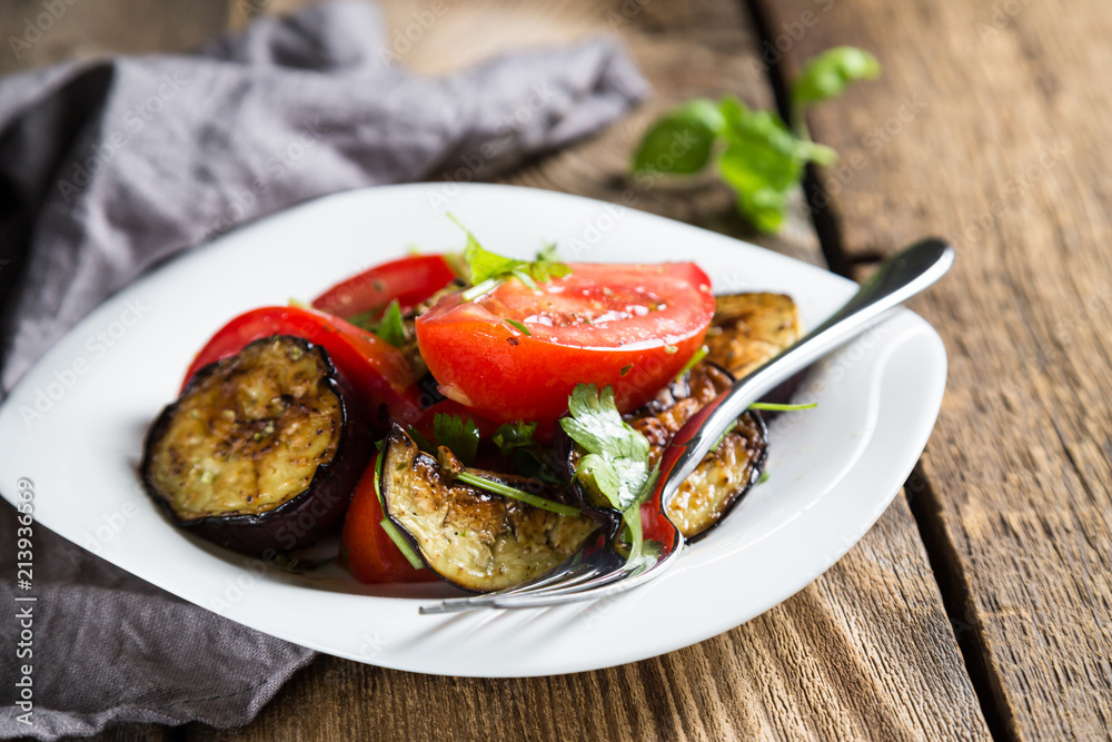 Salad of baked eggplants and fresh tomatoes with parsley Salad of baked eggplants and fresh tomatoes with parsley