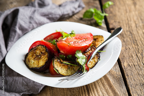 Salad of baked eggplants and fresh tomatoes with parsley