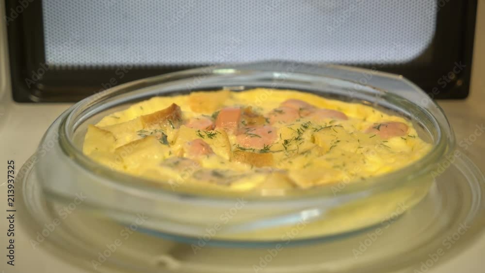 Omelette with croutons and sausage spins inside microwave oven Omelette with croutons and sausage spins inside microwave oven