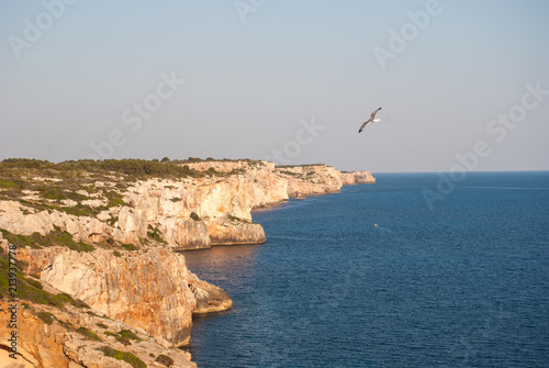 Coast of red rocks of Cala en Porter of Menorca