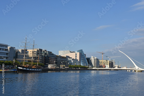 Canvas Print Sailing ship on River Liffey, Samuel Beckett Bridge and CCD in Dublin, Ireland