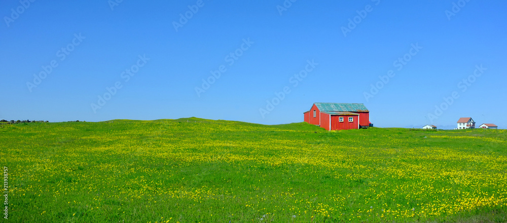 a small red hut in a green field in Iceland a small red hut in a green field in Iceland