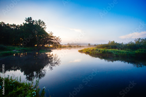 Quiet sunrise over river curve in Belarus. Silence at daybreak in summer