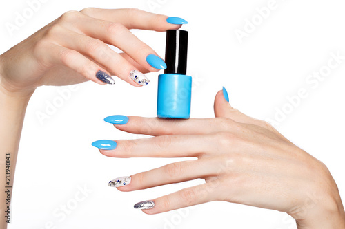 Beautiful summer blue manicure on female hand with nail polish. Close-up. Picture taken in the studio