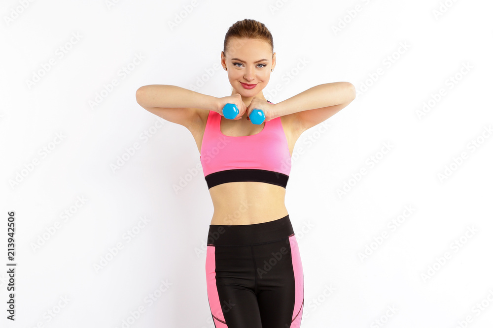 Young girl athlete, fitness with dumbbells isolated on white background Young girl athlete, fitness with dumbbells isolated on white background
