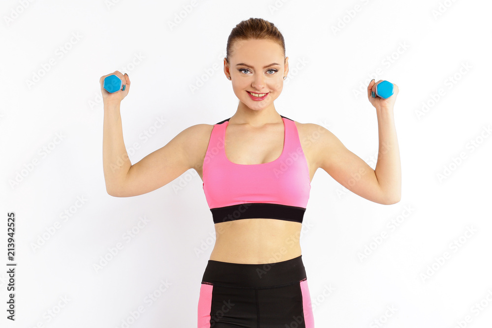 Young girl athlete, fitness with dumbbells isolated on white background Young girl athlete, fitness with dumbbells isolated on white background