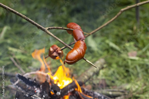 Fotografie Roast sausage over the fire
