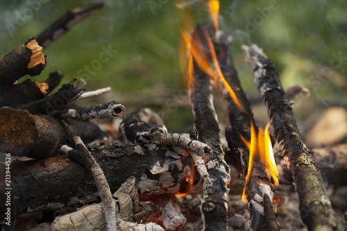 Burning campfire. Burning wooden sticks. Camping in nature and making a campfire. Campfire burning bright. Burning campfire in forest. Campfire at tourist camp at nature. Fuel, power and energy
