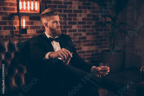 Posh chic wealthy lifestyle concept. Profile side-view portrait of serious thinking focused concentrated pensive stylish trendy rich arrogant freelancer chief sharp-dressed holding cigar beverage