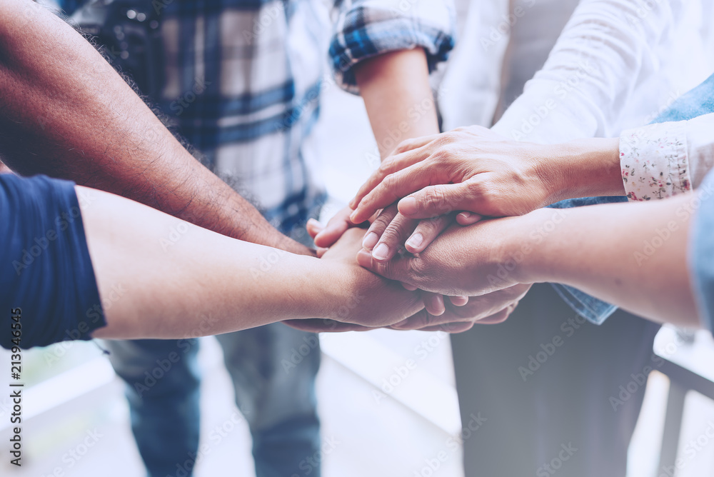 Fototapeta premium People hand assemble as a connection meeting teamwork concept. Group of people colleague assembly hands as a business or work achievement. Man and women touch each other hands. Teamwork conceptual.