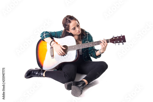 beautiful young girl playing the guitar
