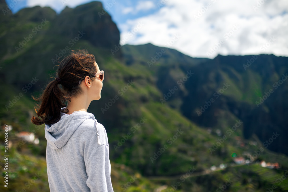 Traveler woman enjoying scenic mountains landscape