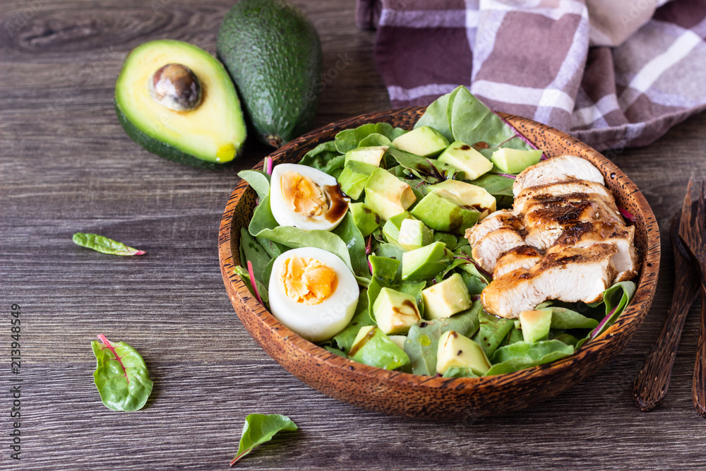 Green lunch bowl with grilled chicken, avocado and eggs. Healthy and dietary food. Space for text. Green lunch bowl with grilled chicken, avocado and eggs. Healthy and dietary food. Space for text.