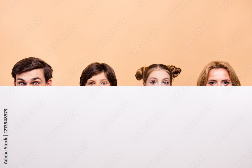 Close up portrait of shy cunning adorable attractive beautiful family, bearded father, blonde mother, boy and girl holding white copy space blank billboard Close up portrait of shy cunning adorable attractive beautiful family, bearded father, blonde mother, boy and girl holding white copy space blank billboard