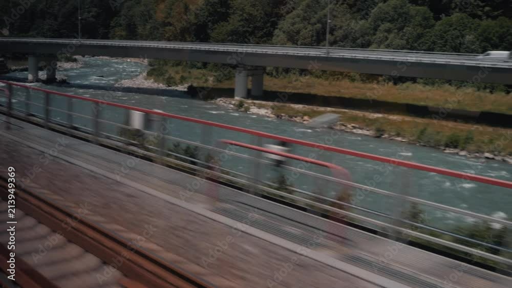 View from the window of a train with a view of the mountains and the forest View from the window of a train with a view of the mountains and the forest