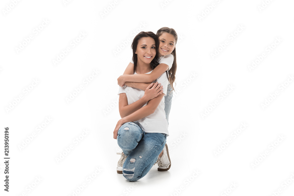 happy daughter hugging mother and looking at camera isolated on white happy daughter hugging mother and looking at camera isolated on white
