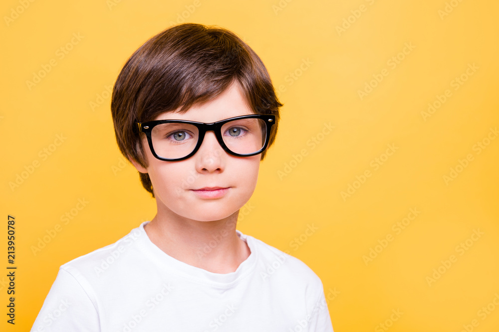 Portrait of attractive young cheerful caucasian school boy, wearing glasses, smiling over yellow background, isolated. Copy space Portrait of attractive young cheerful caucasian school boy, wearing glasses, smiling over yellow background, isolated. Copy space