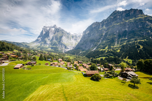 Sunny view of alpine Eiger village. Location place Swiss alps, Grindelwald valley. photo