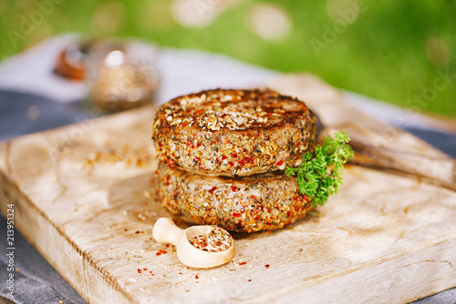 lamb burgers spiced by mint and lamb rub on wood board photo