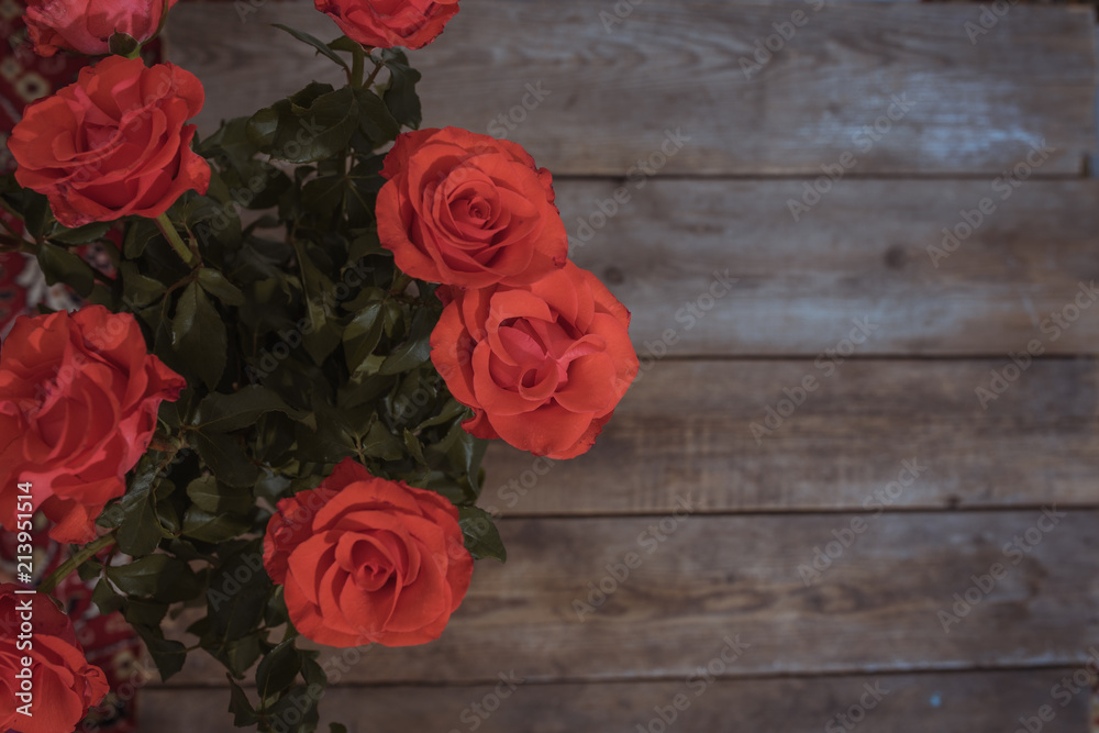 Beautiful red roses on wooden background. Copy space Beautiful red roses on wooden background. Copy space