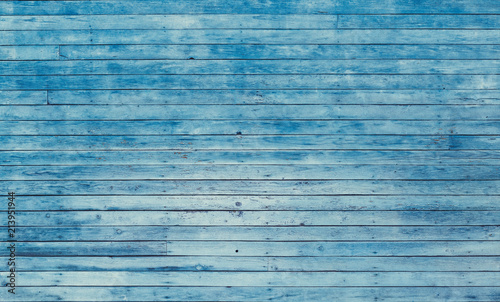 Old blue shabby wooden planks with cracked color paint