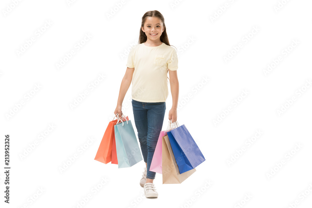 smiling kid with shopping bags isolated on white