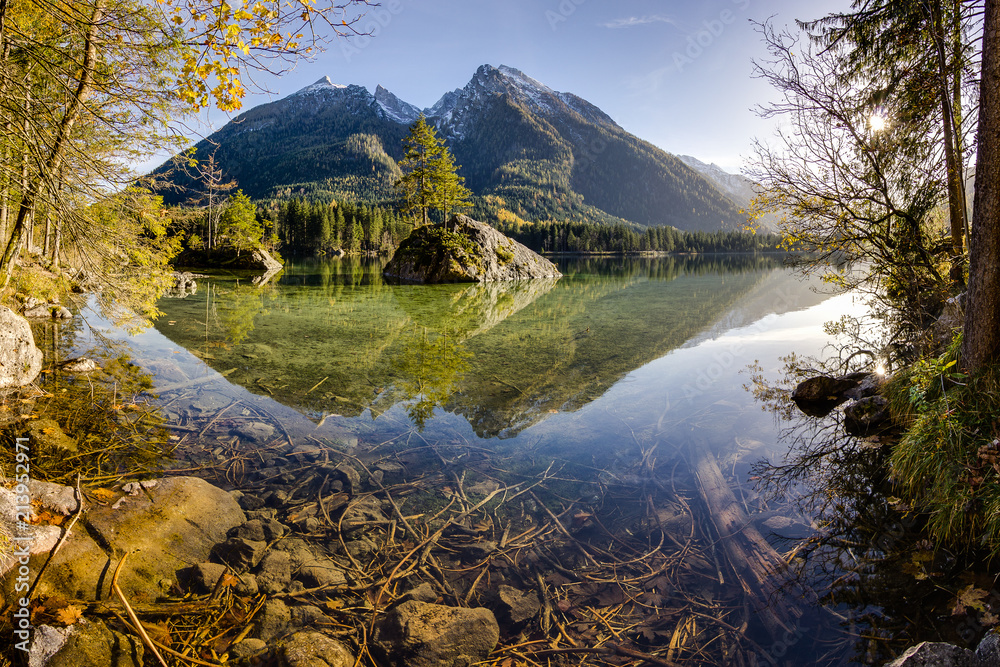 Mountains reflected in crystal clear water of nearby lake