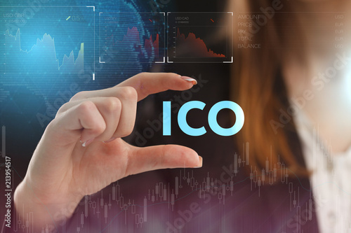 The concept of business, technology, the Internet and the network. A young entrepreneur working on a virtual screen of the future and sees the inscription: ICO