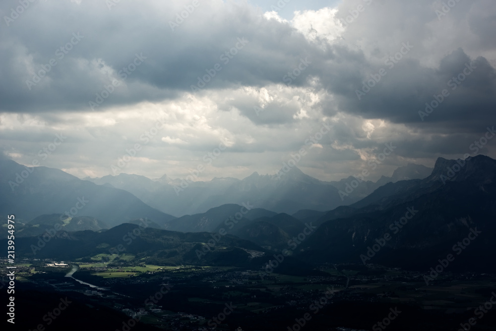 Dark and cloudy sky over a city in the alps