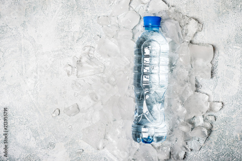 water in bottle on a background of ice. Health detox concept