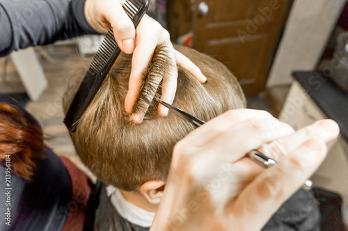 hairdresser cuts a man close up