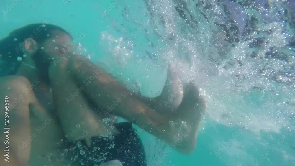 Beautiful pictures of young man playing in the pool, submerged with many bubbles Beautiful pictures of young man playing in the pool, submerged with many bubbles