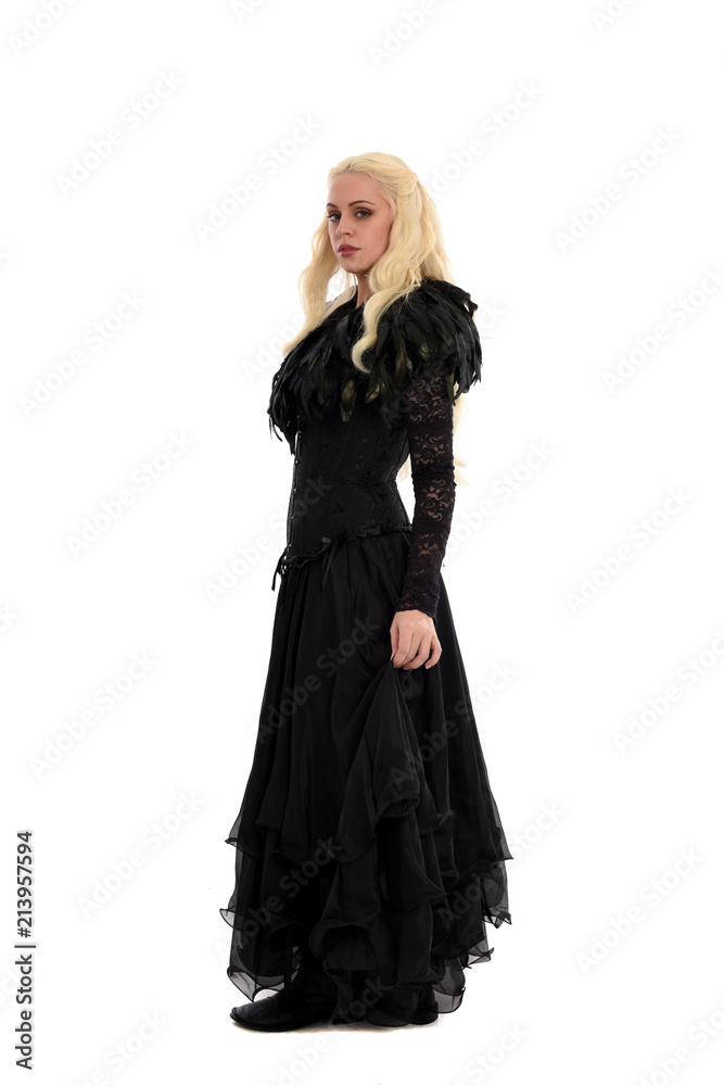 full length portrait of blonde girl wearing corset and long black gown. isolated on white studio background, full length portrait of blonde girl wearing corset and long black gown. isolated on white studio background,