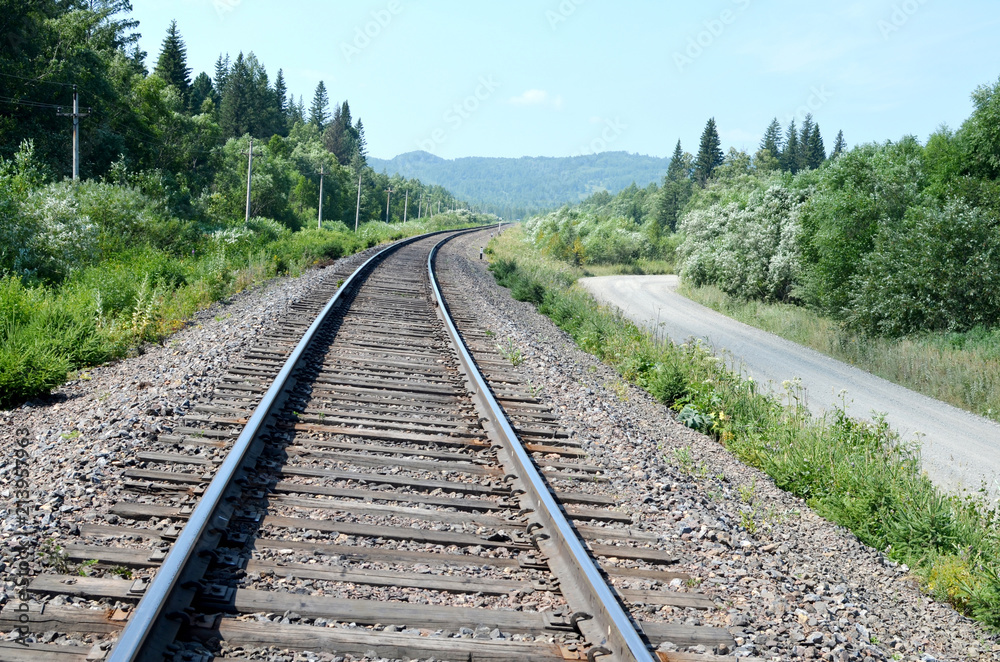Fototapeta premium the rotation of the Railways and country roads on the background of wild nature in summer day