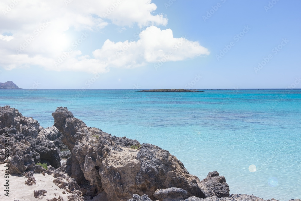 Landscape with seaside beach rocks and turquoise clear water, in summer