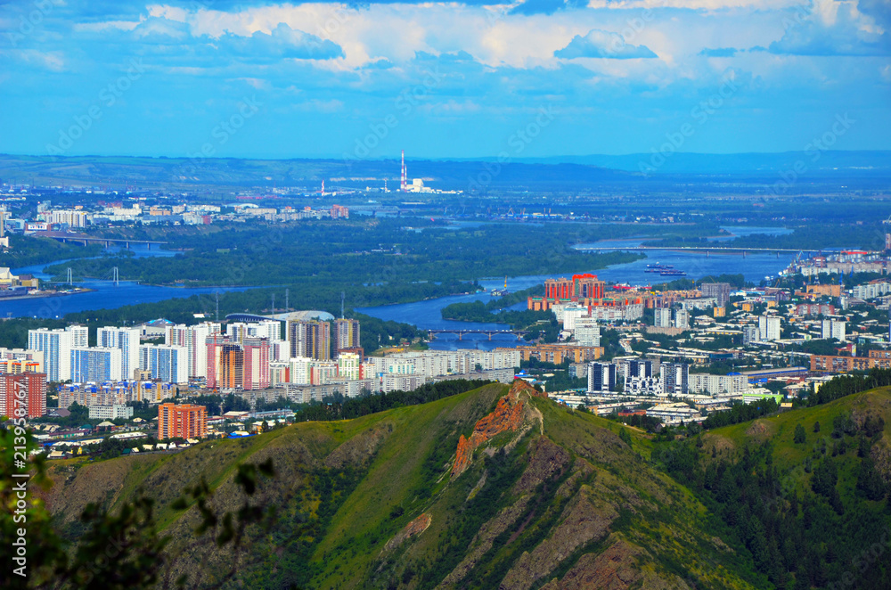 City with mountains in the background. Urban landscape. Megalopolis. Big city. City on the river Bank.