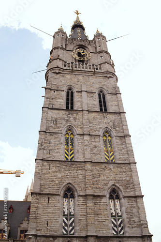 The medieval belfry of Ghent is visible to the street in front of the Botermarkt , Belgium photo