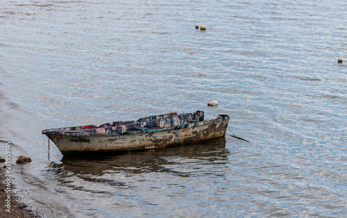 Old fishing boat on the shores of Golfito, Costa Rica.  Day to day life in the small village of Golfito, Costa Rica. photo