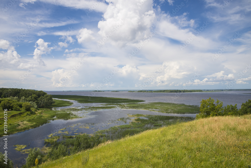Panoramic view of the river, meadows and clouds Panoramic view of the river, meadows and clouds